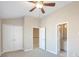 Bedroom with neutral carpet, ceiling fan, and access to closets and bathroom at 572 Vinings Estates Se Dr # B9, Mableton, GA 30126
