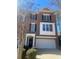 A brick two-story townhouse featuring a large two-car garage and classic architectural details at 572 Vinings Estates Se Dr # B9, Mableton, GA 30126