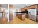 Open kitchen view showcasing stainless steel refrigerator, granite counters, wood cabinets and island at 572 Vinings Estates Se Dr # B9, Mableton, GA 30126