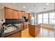 Well-lit kitchen featuring wood cabinets, granite countertops, stainless steel appliances and a kitchen island at 572 Vinings Estates Se Dr # B9, Mableton, GA 30126