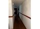 Long hallway with neutral walls and hardwood flooring provides access to multiple rooms at 2765 Rollingwood Se Ln, Atlanta, GA 30316