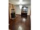 Warm living room featuring hardwood floors, brick fireplace and elegant chandelier at 2765 Rollingwood Se Ln, Atlanta, GA 30316