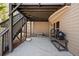 Covered patio area with a grill and seating area provides a functional outdoor space for entertaining at 2820 Garonne Way, Cumming, GA 30041