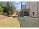 Exterior view of home shows backyard with stairs to deck and lower-level patio area at 2820 Garonne Way, Cumming, GA 30041