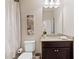 Bathroom featuring tile flooring, granite vanity, decorative mirror, and a shower with glass doors at 2820 Garonne Way, Cumming, GA 30041