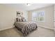 Cozy bedroom featuring neutral decor, plush carpeting, and a window providing natural light at 2820 Garonne Way, Cumming, GA 30041