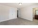Spacious bedroom with plush carpeting, neutral walls, and a doorway leading to an attached bathroom at 2820 Garonne Way, Cumming, GA 30041