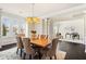 Bright dining room with natural light, light-colored walls, decorative chandelier, and dark hardwood floors at 2820 Garonne Way, Cumming, GA 30041