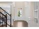 Bright entryway featuring a staircase, wainscoting, and wood floors at 2820 Garonne Way, Cumming, GA 30041