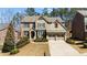 Charming brick two-story home with manicured landscaping, and a two-car garage at 2820 Garonne Way, Cumming, GA 30041