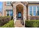 Charming front entrance with stone archway, brick steps, and well-maintained landscaping at 2820 Garonne Way, Cumming, GA 30041