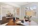 View of front entry, dining room, and home office space featuring dark hardwood floors and neutral walls at 2820 Garonne Way, Cumming, GA 30041
