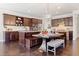 Spacious kitchen with stainless appliances, dark wood cabinetry, and unique dining table at 2820 Garonne Way, Cumming, GA 30041
