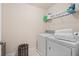Functional laundry room with modern washer and dryer, storage shelves, and ample counter space at 2820 Garonne Way, Cumming, GA 30041