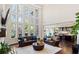 Bright living room with a wall of windows, dark hardwood floors, recessed lighting, and an open concept to the kitchen at 2820 Garonne Way, Cumming, GA 30041