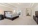 Spacious main bedroom with tray ceilings, plush carpeting, and attached bathroom at 2820 Garonne Way, Cumming, GA 30041