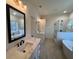Contemporary bathroom featuring double vanities, soaking tub, and tiled shower with glass door at 34 Harmony Ridge Dr, Temple, GA 30179