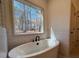 Bright bathroom with large window, soaker tub, and tile surround at 34 Harmony Ridge Dr, Temple, GA 30179