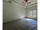 The primary bedroom boasts a ceiling fan and a large window with natural light at 34 Harmony Ridge Dr, Temple, GA 30179