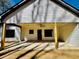 View of the covered back patio with a stained wood ceiling and ceiling fan overlooking the backyard at 34 Harmony Ridge Dr, Temple, GA 30179