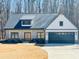 Charming new construction farmhouse featuring a 2-car garage, stone accents, and a covered front porch at 34 Harmony Ridge Dr, Temple, GA 30179