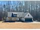 Charming new construction farmhouse featuring a 2-car garage, stone accents, and a covered front porch at 34 Harmony Ridge Dr, Temple, GA 30179