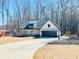 Charming new construction farmhouse featuring a 2-car garage, stone accents, and a covered front porch at 34 Harmony Ridge Dr, Temple, GA 30179