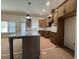 An open concept kitchen features an island with granite countertops and wooden cabinets at 34 Harmony Ridge Dr, Temple, GA 30179