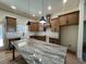 Spacious kitchen with granite counters, stainless hood, apron sink and modern lighting at 34 Harmony Ridge Dr, Temple, GA 30179