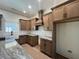 A stunning kitchen features wood cabinets, granite countertops, and a farmhouse sink at 34 Harmony Ridge Dr, Temple, GA 30179