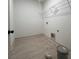Bright laundry area with tile flooring, shelf system, and washer-dryer hookups at 34 Harmony Ridge Dr, Temple, GA 30179