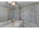 Bathroom with a white marble-like tile and bathtub at 376 Provenance Dr, Atlanta, GA 30328