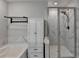 Clean white bath with a glass-enclosed shower and built-in linen cupboard for a clutter-free and organized look at 376 Provenance Dr, Atlanta, GA 30328