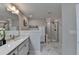 Elegant bathroom boasts double sinks with white cabinets, shower, soaking tub, and marble floors for a modern look at 376 Provenance Dr, Atlanta, GA 30328
