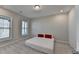 Bedroom with neutral carpet, two large windows, and minimal decor; simple and serene atmosphere at 376 Provenance Dr, Atlanta, GA 30328
