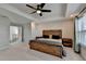 Main bedroom with ensuite bathroom, vaulted ceilings, and a ceiling fan at 376 Provenance Dr, Atlanta, GA 30328