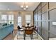 Dining area with wood table, adjacent to the kitchen and living room at 376 Provenance Dr, Atlanta, GA 30328