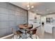Stylish dining area with a wooden table and gray accent wall, open to the modern kitchen at 376 Provenance Dr, Atlanta, GA 30328