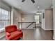 Bright foyer features a red accent chair, hardwood floors, and staircase at 376 Provenance Dr, Atlanta, GA 30328