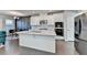 Kitchen with white cabinets, stainless steel appliances, island and wood flooring at 376 Provenance Dr, Atlanta, GA 30328