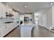 Kitchen features white cabinetry, island, and hardwood floors at 376 Provenance Dr, Atlanta, GA 30328