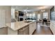 Kitchen with white cabinets and large island, open to the living room at 376 Provenance Dr, Atlanta, GA 30328