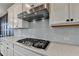 Modern kitchen with stainless steel range hood and quartz countertops at 376 Provenance Dr, Atlanta, GA 30328