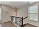 Upstairs landing featuring hardwood floors and staircase at 376 Provenance Dr, Atlanta, GA 30328