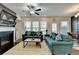 Spacious living room featuring comfortable sofas, fireplace, and a view of the dining area at 376 Provenance Dr, Atlanta, GA 30328