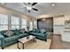 Bright living room with comfortable teal sofas and view into the kitchen and dining area at 376 Provenance Dr, Atlanta, GA 30328