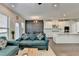 Open floor plan showing the living room with sofas and the dining and kitchen area at 376 Provenance Dr, Atlanta, GA 30328