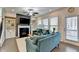 Bright living room featuring a fireplace, built-in shelving, and comfortable blue sofas at 376 Provenance Dr, Atlanta, GA 30328