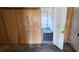 Unfinished basement space with plywood walls and an open doorway at 868 Maxey Hill Ct, Stone Mountain, GA 30083