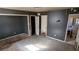 View of a bedroom featuring a neutral color scheme, multiple doorways, and worn floors at 868 Maxey Hill Ct, Stone Mountain, GA 30083